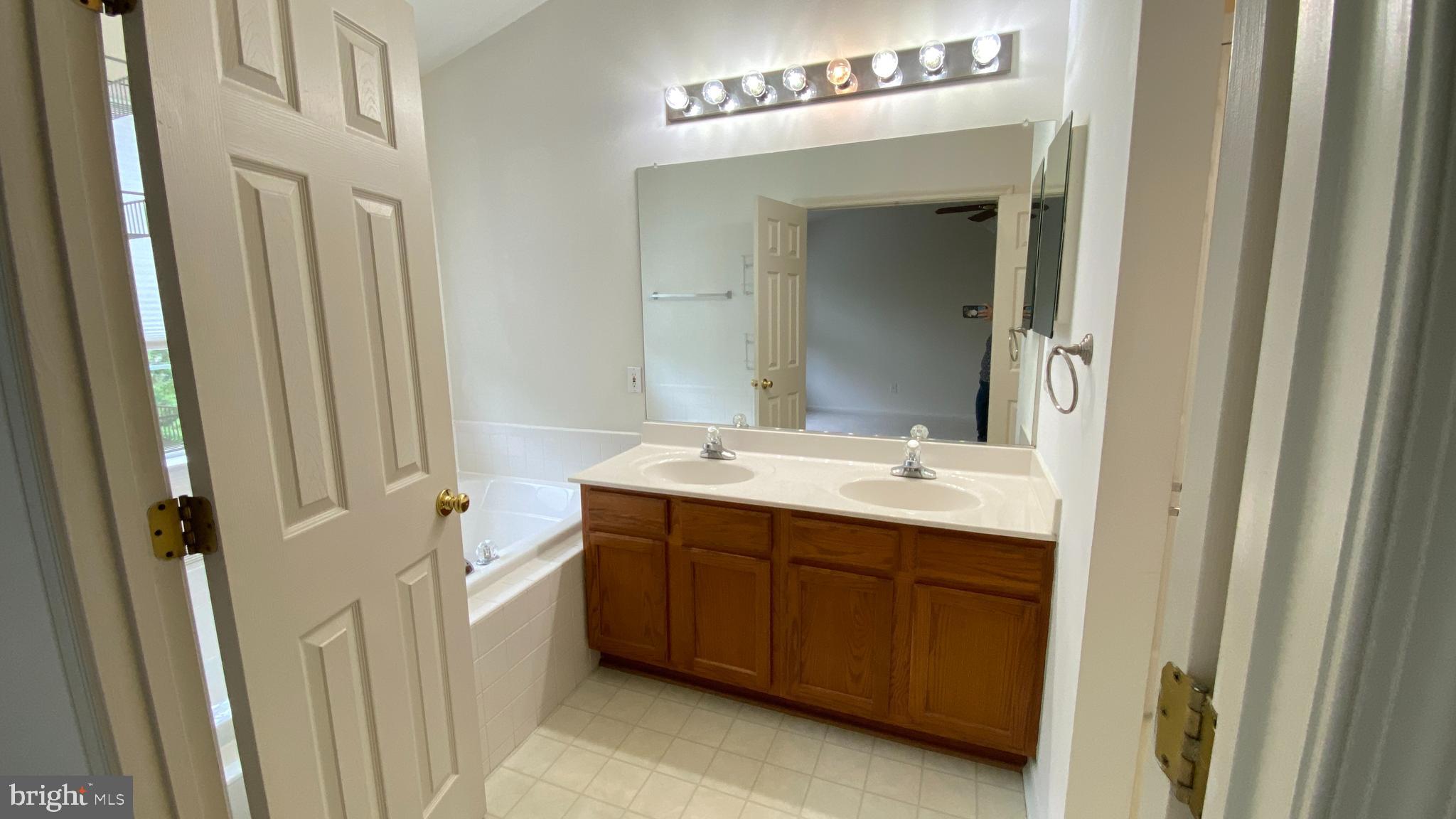 8231 Ramseur Place Manassas, VA 20109 - Photo 7 of 16 a bathroom with a double vanity sink and mirror