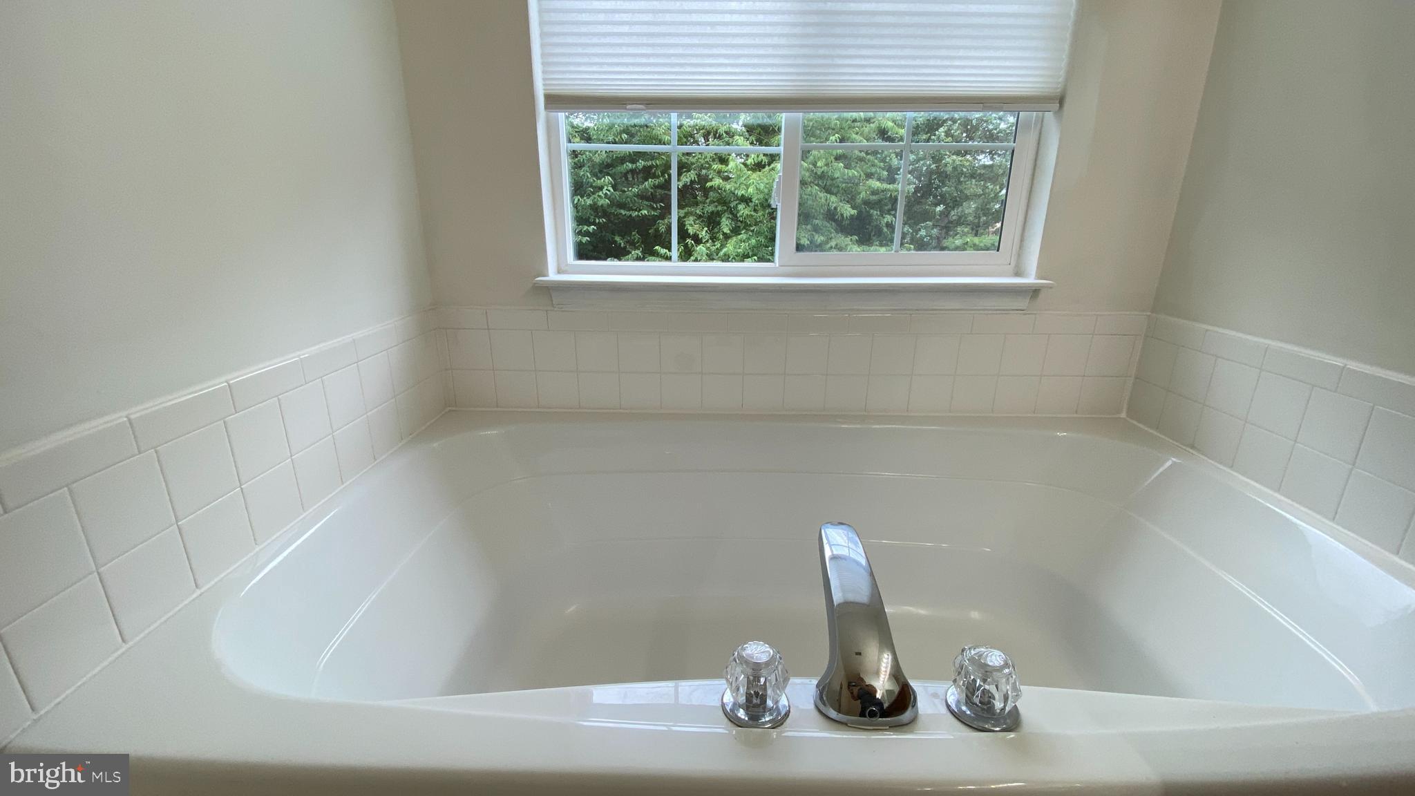 8231 Ramseur Place Manassas, VA 20109 - Photo 8 of 16 a bath tub sitting in a bathroom next to a window