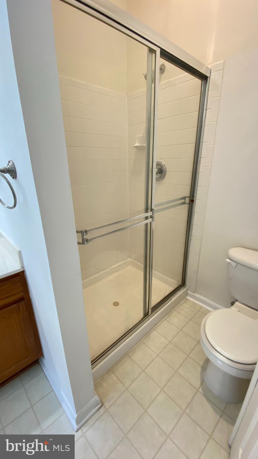 8231 Ramseur Place Manassas, VA 20109 - Photo 9 of 16 a white toilet sitting next to a shower