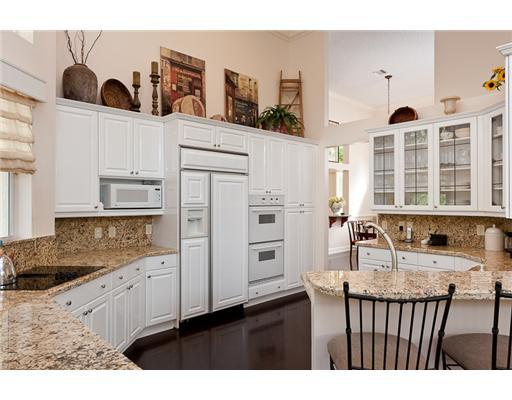 6329 Northwest 23rd Way Boca Raton, FL 33496 - Photo 3 of 10 a kitchen with stainless steel appliances granite countertop a refrigerator a stove and white cabinets with wooden floor