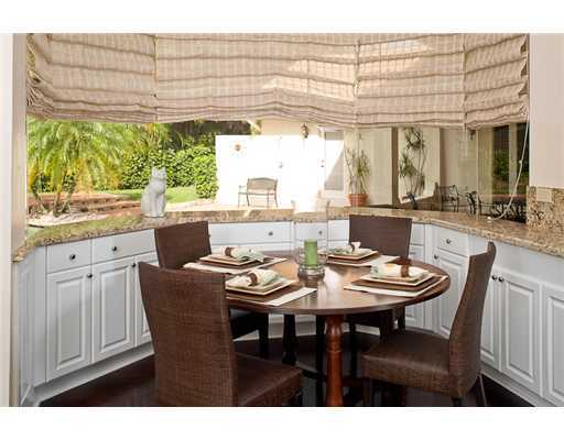 6329 Northwest 23rd Way Boca Raton, FL 33496 - Photo 4 of 10 a dining room with furniture a chandelier and wooden floor