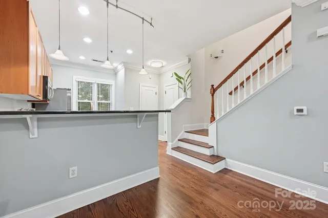 a view of entryway and hall with wooden floor