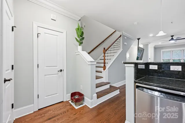 a view of entryway and hall with wooden floor