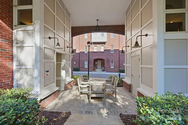 a building outdoor space with patio furniture and potted plants