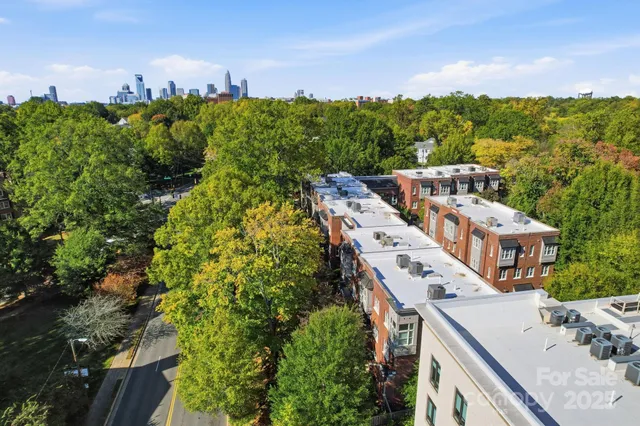 an aerial view of a house with a yard and lake view