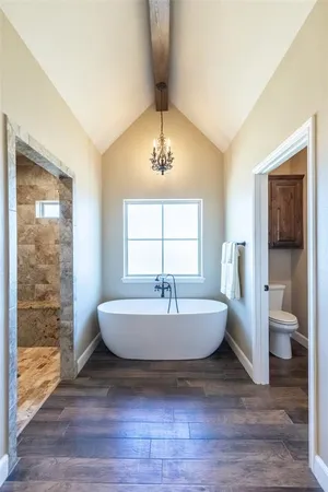 a spacious bathroom with a bathtub and a sink