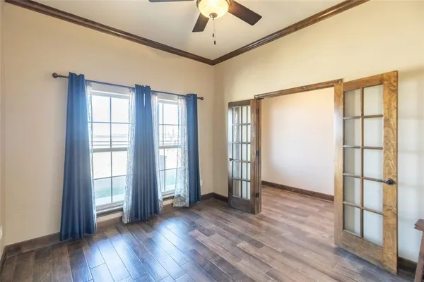 wooden floor in an empty room with a window