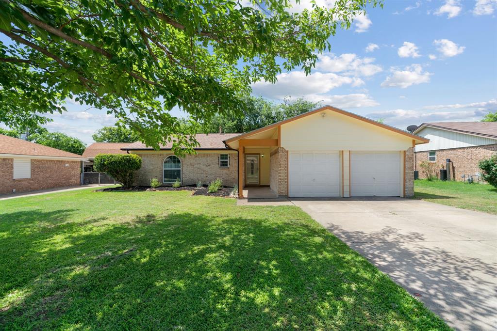 220 East Cunningham Avenue Crowley, TX 76036 - Photo 1 of 1 a front view of a house with a yard and a garage