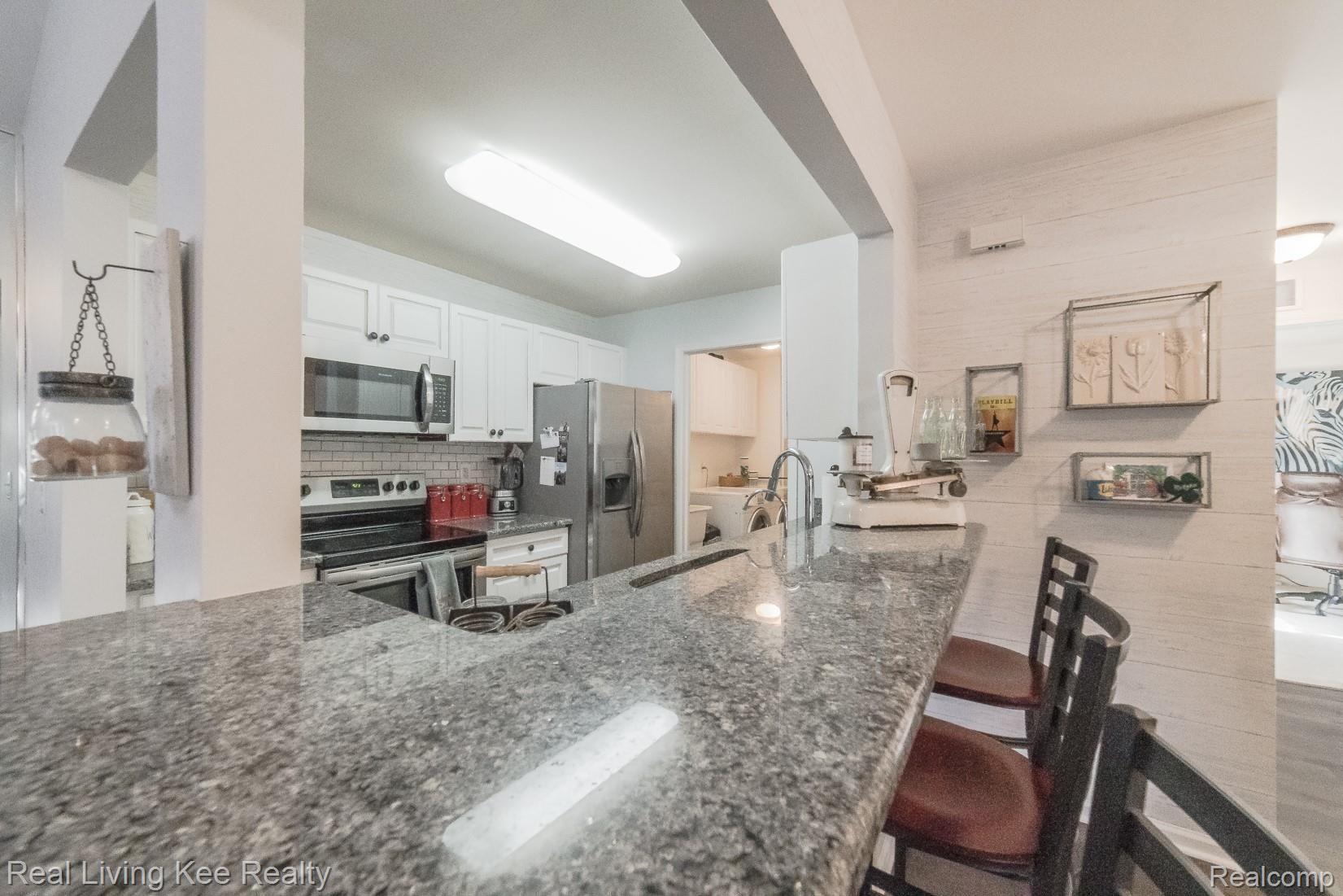 3565 Tremonte Circle, Unit 244 Rochester, MI 48306 - Photo 14 of 29 Extended granite counters