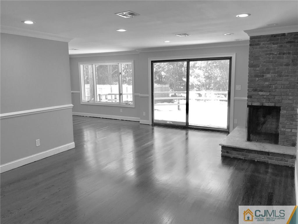 738 West Foothill Road Bridgewater, NJ 08807 - Photo 14 of 22 an empty room with wooden floor and fireplace