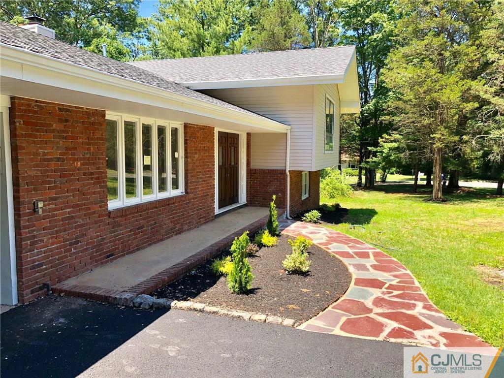 738 West Foothill Road Bridgewater, NJ 08807 - Photo 3 of 22 a front view of a house with a yard
