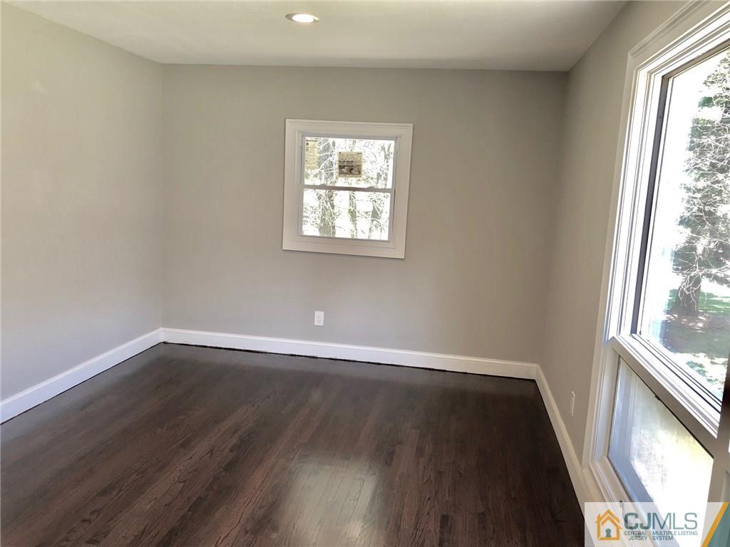 738 West Foothill Road Bridgewater, NJ 08807 - Photo 22 of 22 a view of an empty room with wooden floor and a window