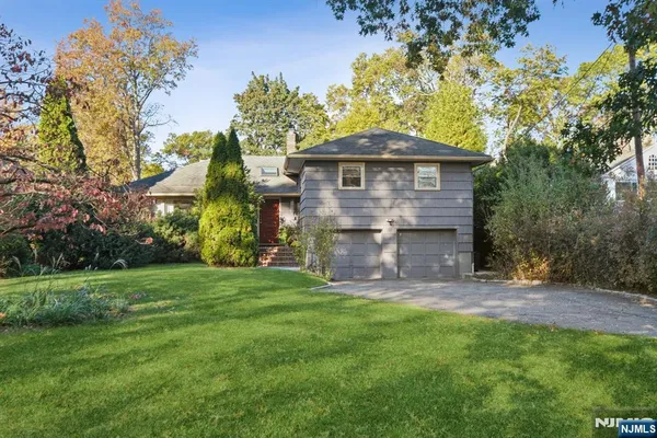 a view of a wooden house with a yard
