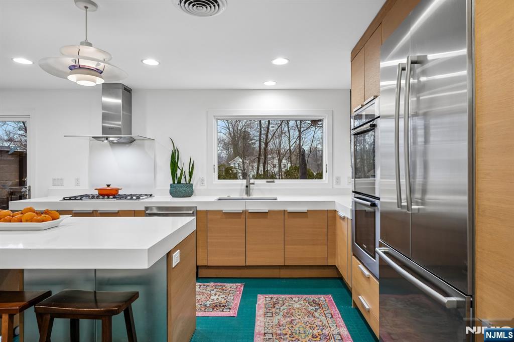 398 Grove Street Montclair, NJ 07043 - Photo 11 of 48 a kitchen with stainless steel appliances a sink stove and refrigerator