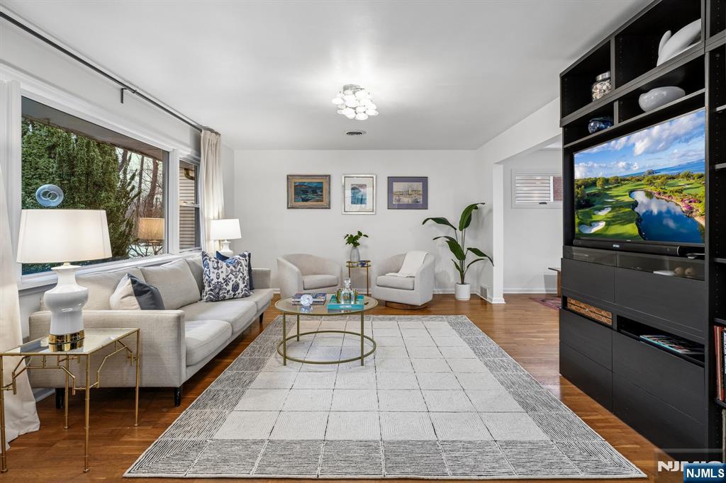 398 Grove Street Montclair, NJ 07043 - Photo 12 of 48 a living room with furniture a flat screen tv and a floor to ceiling window
