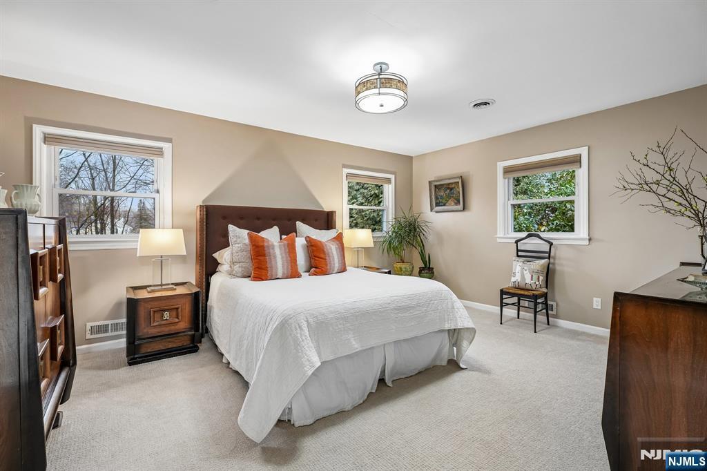 398 Grove Street Montclair, NJ 07043 - Photo 17 of 48 a bedroom with a bed and a table in it with window