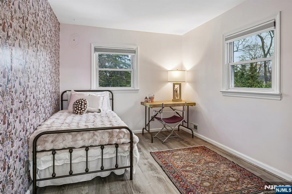 398 Grove Street Montclair, NJ 07043 - Photo 19 of 48 a bedroom with a bed a lamp and a window