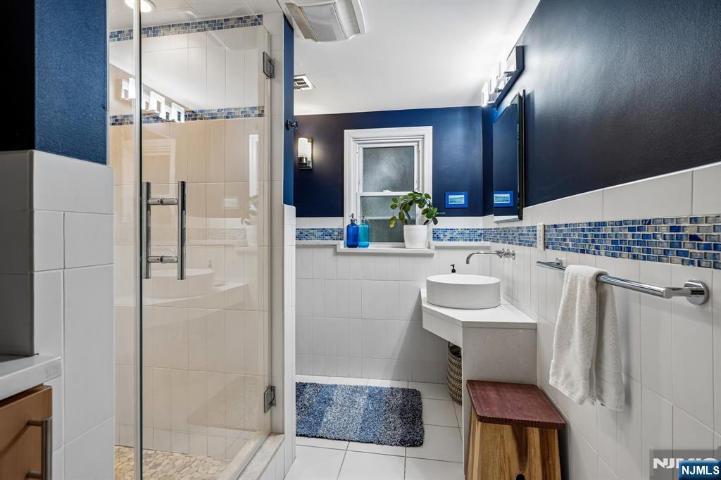 398 Grove Street Montclair, NJ 07043 - Photo 24 of 48 a bathroom with a sink and a mirror