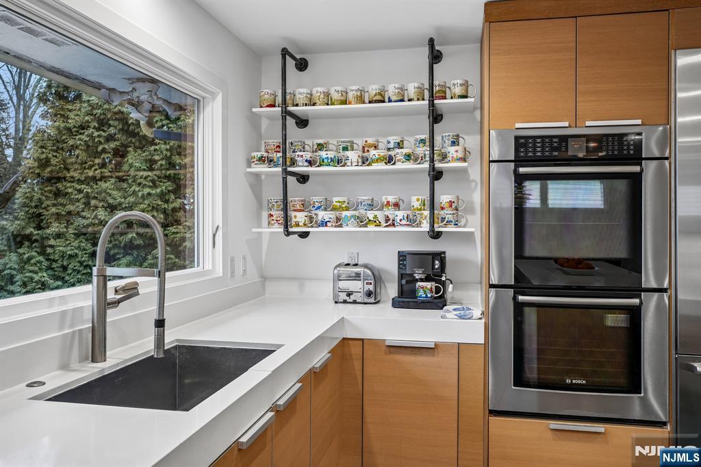 398 Grove Street Montclair, NJ 07043 - Photo 9 of 48 a kitchen with a sink a stove and cabinets