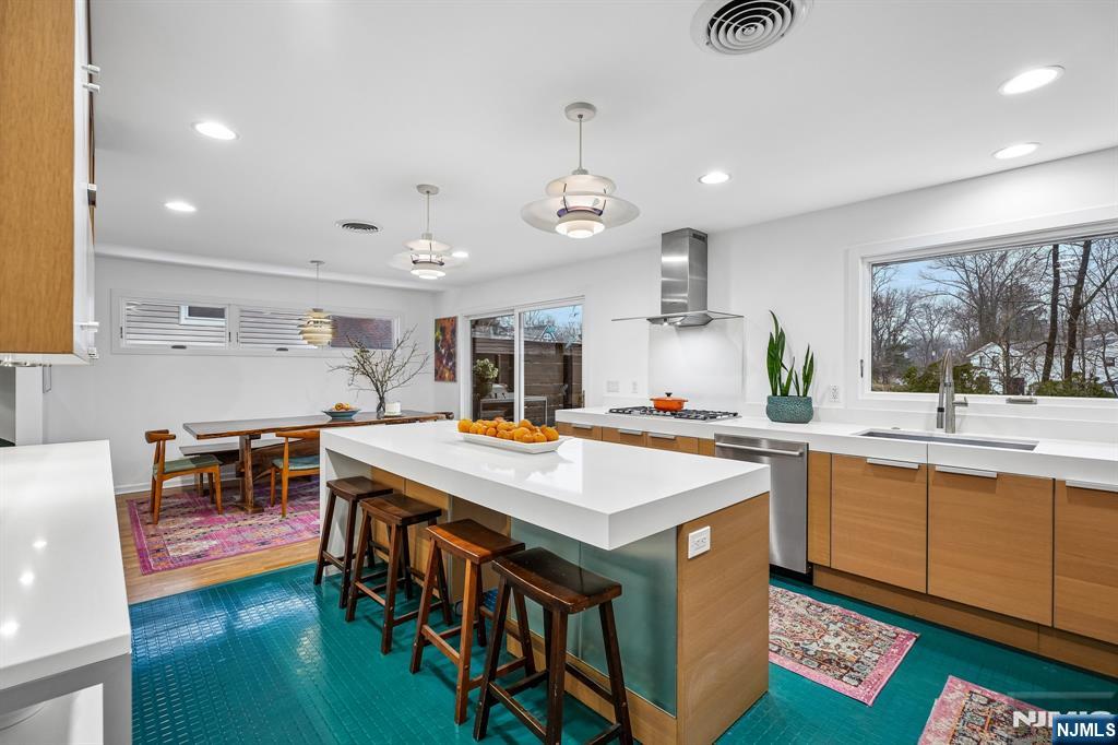 398 Grove Street Montclair, NJ 07043 - Photo 10 of 48 a kitchen with stainless steel appliances granite countertop a sink and a stove