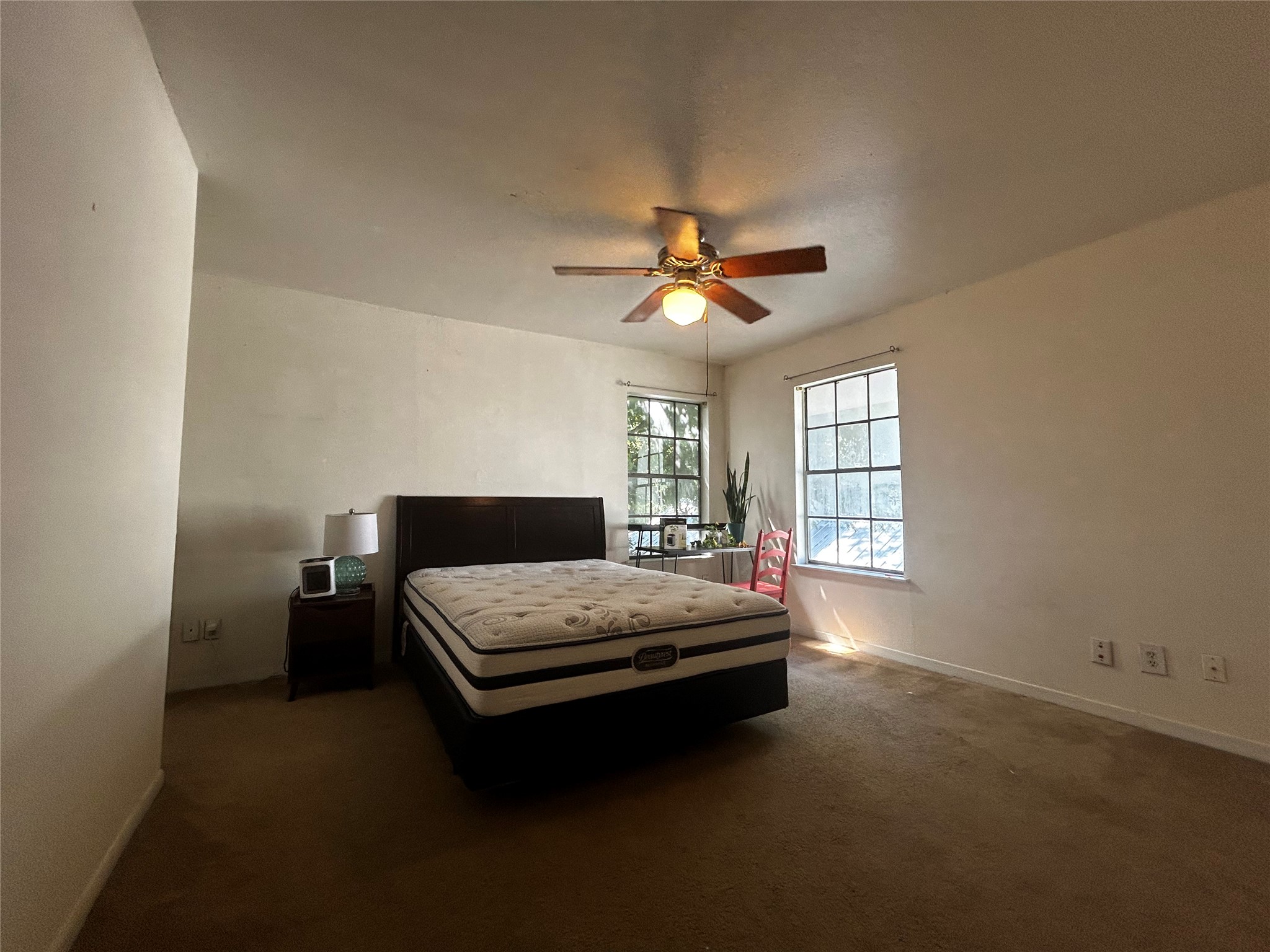 4511 Avenue B, Unit B Austin, TX 78751 - Photo 8 of 15 Bedroom with dark carpet and a ceiling fan