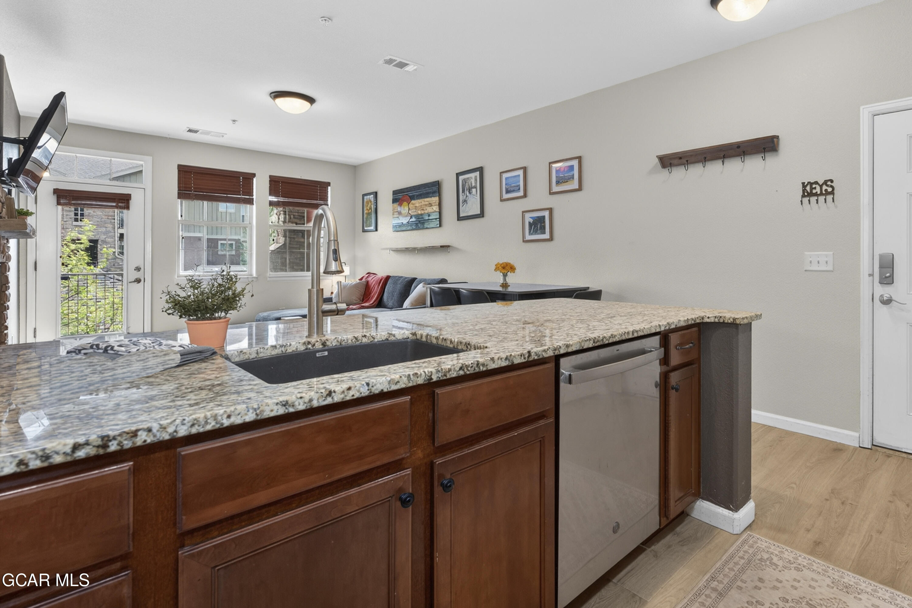 158 Village Road Granby, CO 80446 - Photo 2 of 46 a kitchen with granite countertop cabinets a sink and potted plant