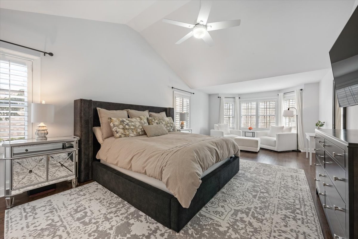 1588 White Oak Road Lake Forest, IL 60045 - Photo 12 of 35 a bedroom with a large bed and a chandelier