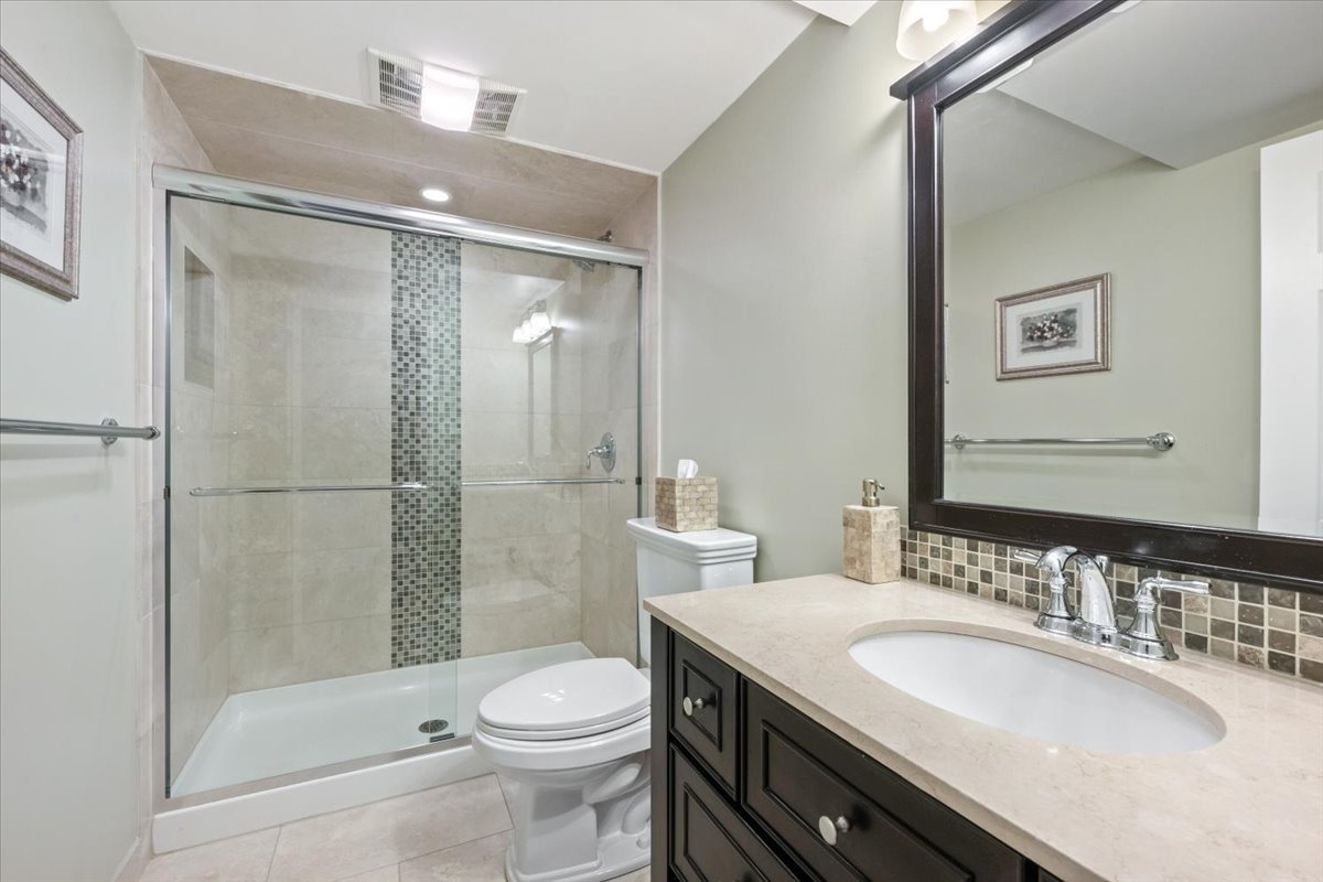 1588 White Oak Road Lake Forest, IL 60045 - Photo 27 of 35 a bathroom with a granite countertop sink toilet and shower