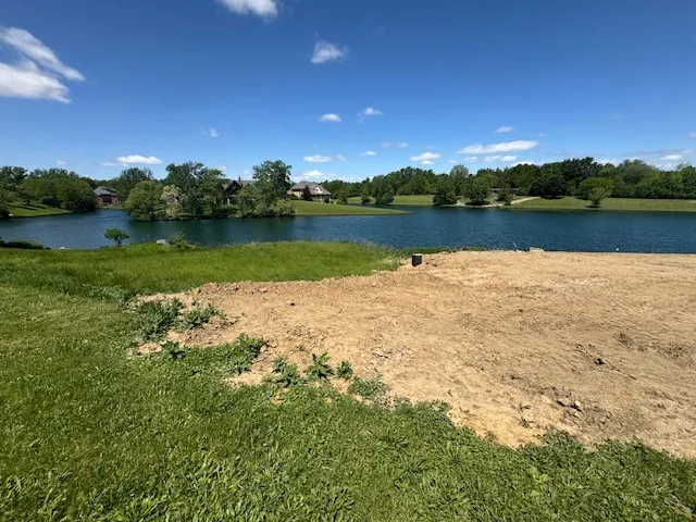 a view of a lake with houses in the background