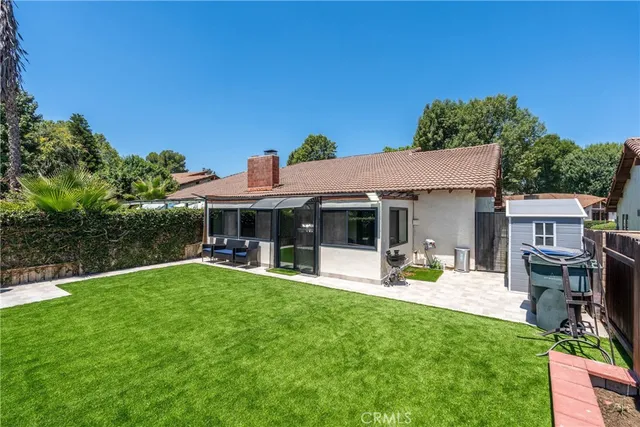 a view of a house with backyard porch and sitting area
