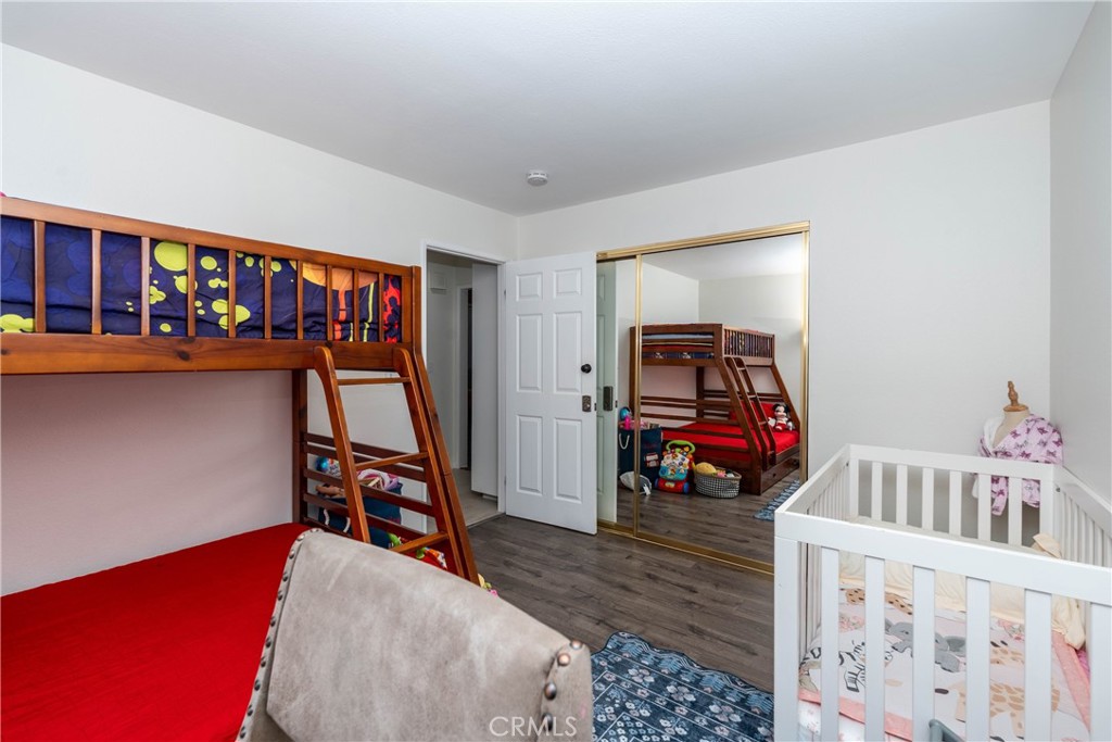 11520 Los Molinos Way Riverside, CA 92505 - Photo 19 of 26 a bedroom with furniture and a book shelf