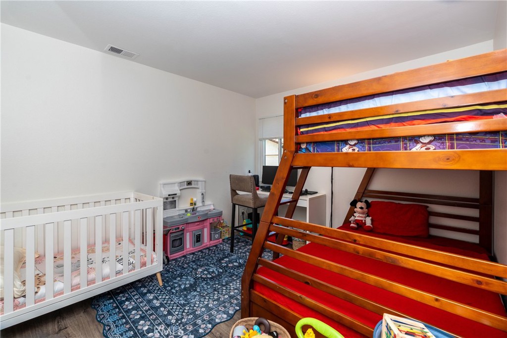 11520 Los Molinos Way Riverside, CA 92505 - Photo 20 of 26 a living room with furniture and a baby crib