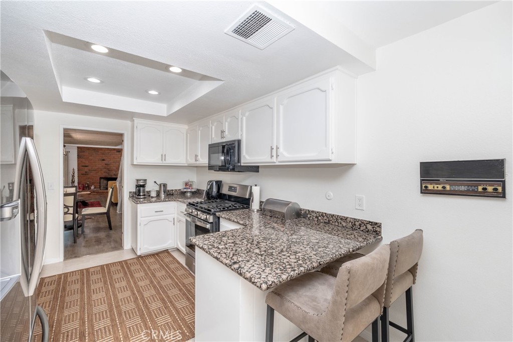 11520 Los Molinos Way Riverside, CA 92505 - Photo 7 of 26 a kitchen with stainless steel appliances granite countertop a sink refrigerator and cabinets