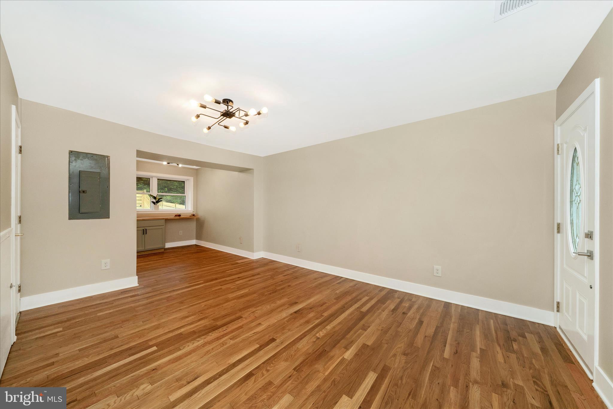 5045 Sheriff Road Northeast Washington, DC 20019 - Photo 1 of 38 wooden floor in an empty room with a window