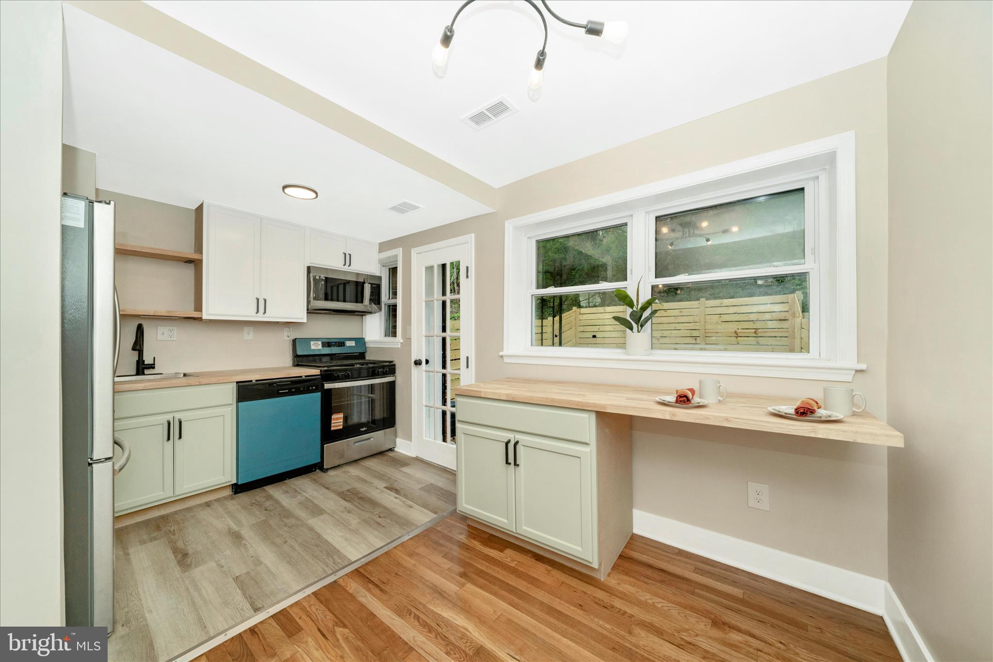5045 Sheriff Road Northeast Washington, DC 20019 - Photo 11 of 38 a large kitchen with stainless steel appliances granite countertop a stove and a sink