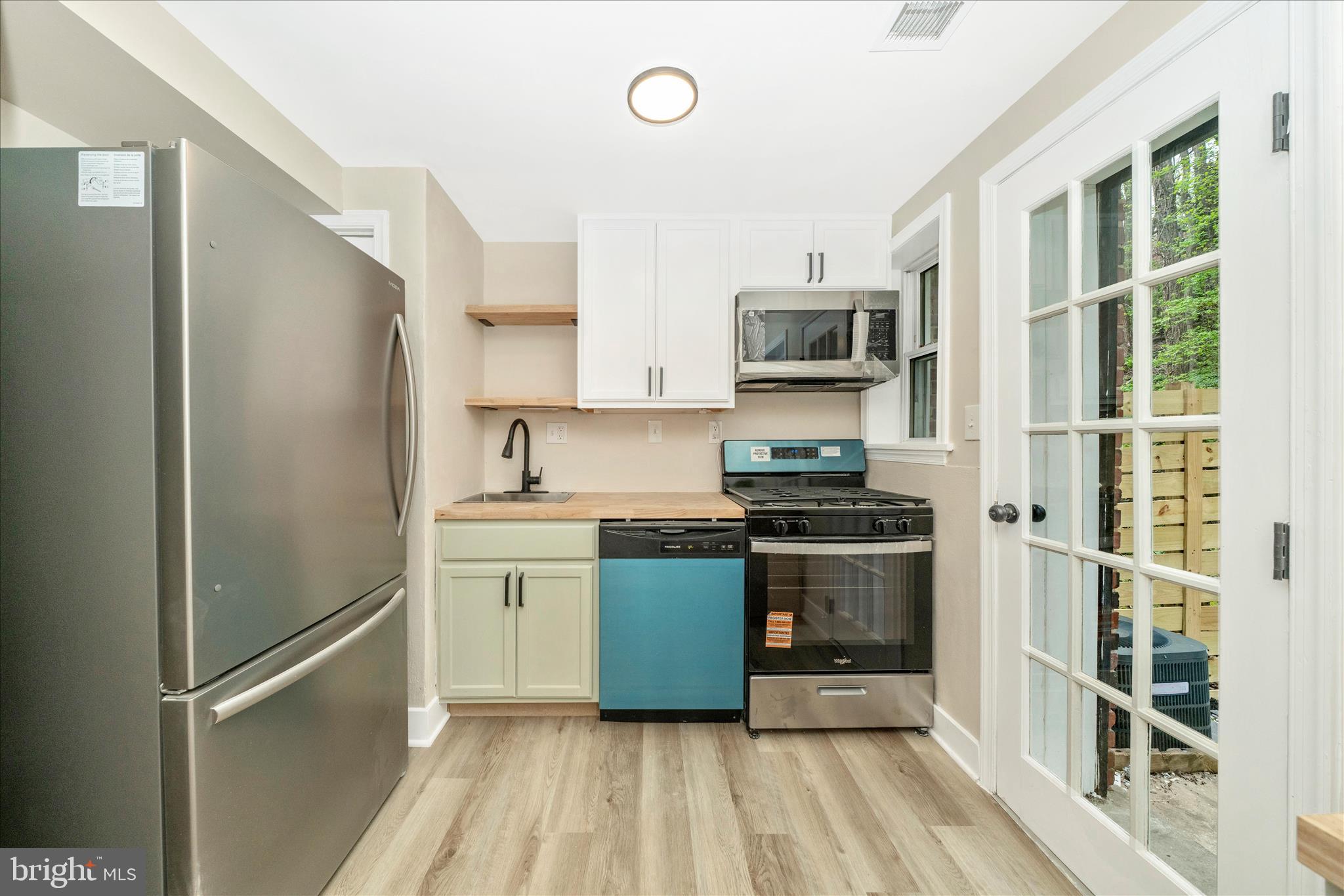 5045 Sheriff Road Northeast Washington, DC 20019 - Photo 12 of 38 a kitchen with stainless steel appliances granite countertop a refrigerator and a sink