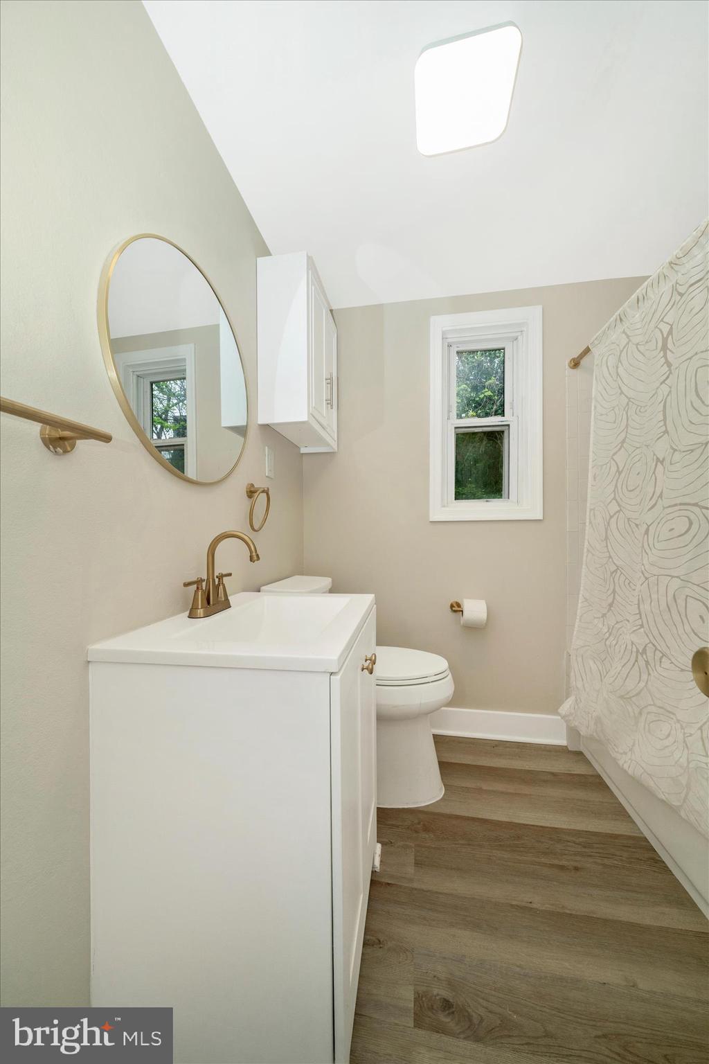 5045 Sheriff Road Northeast Washington, DC 20019 - Photo 19 of 38 a bathroom with a toilet sink and mirror
