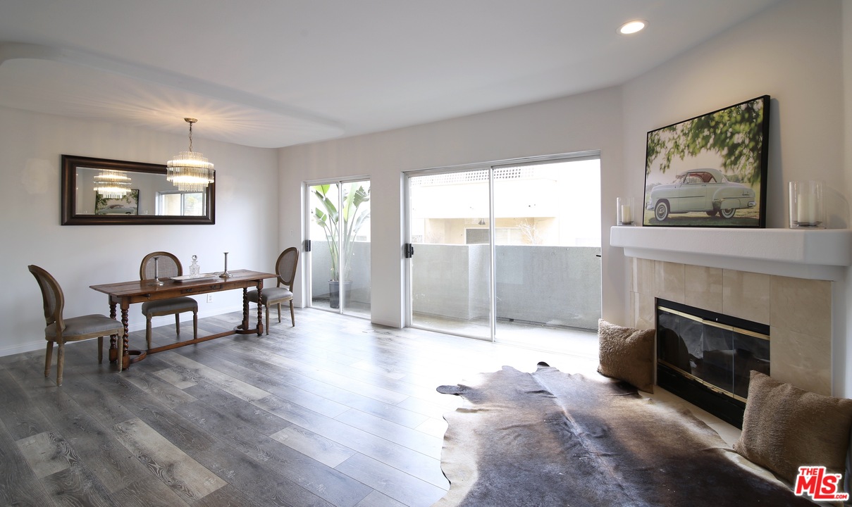 1811 Manning Avenue, Unit 202 Los Angeles, CA 90025 - Photo 1 of 18 a living room with furniture a fireplace and a table