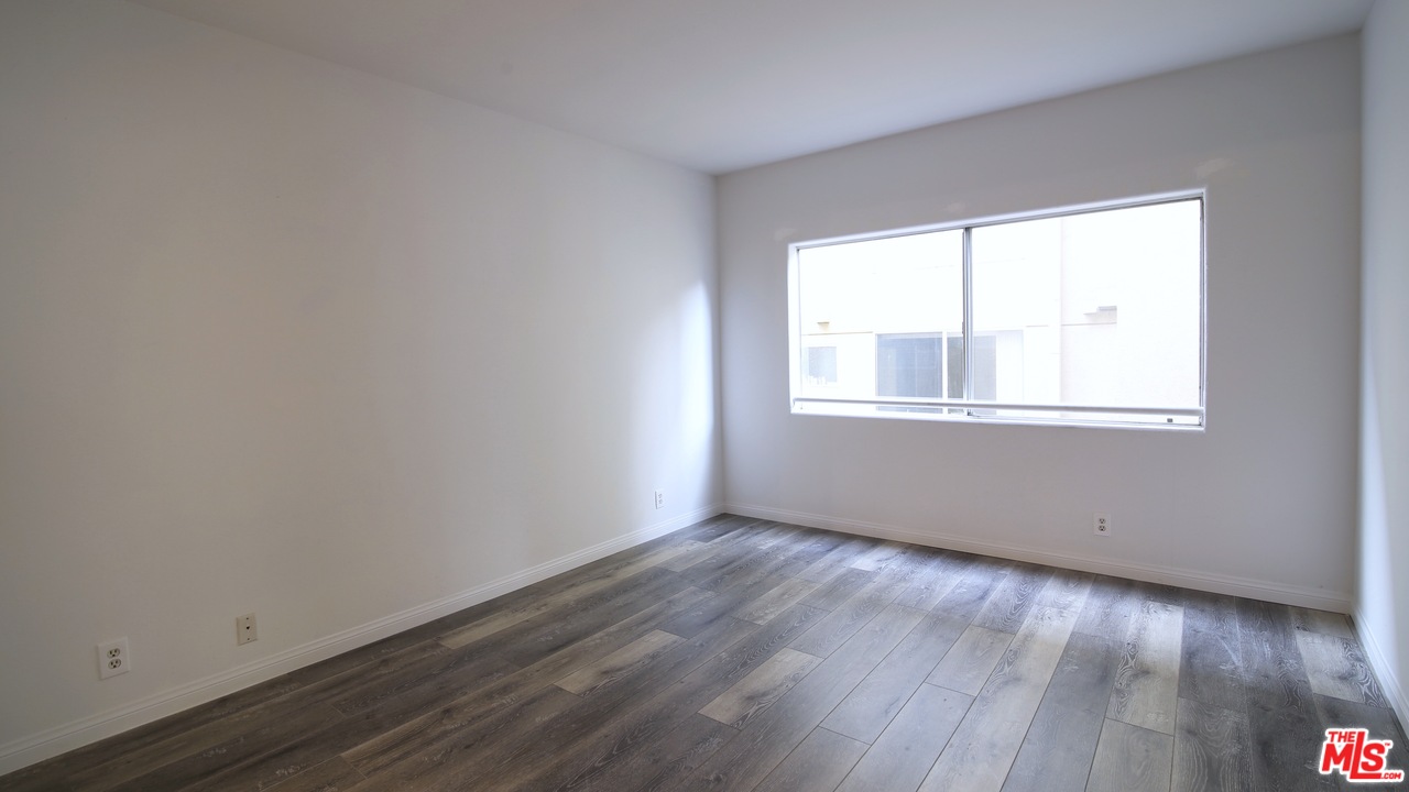 1811 Manning Avenue, Unit 202 Los Angeles, CA 90025 - Photo 11 of 18 an empty room with wooden floor and windows