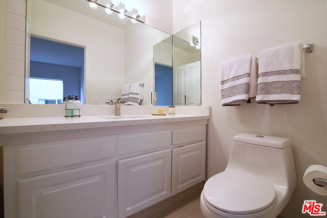 1811 Manning Avenue, Unit 202 Los Angeles, CA 90025 - Photo 12 of 18 a bathroom with a toilet sink and mirror
