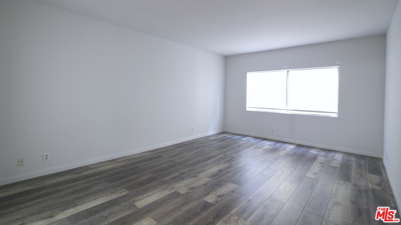 1811 Manning Avenue, Unit 202 Los Angeles, CA 90025 - Photo 13 of 18 an empty room with wooden floor and windows