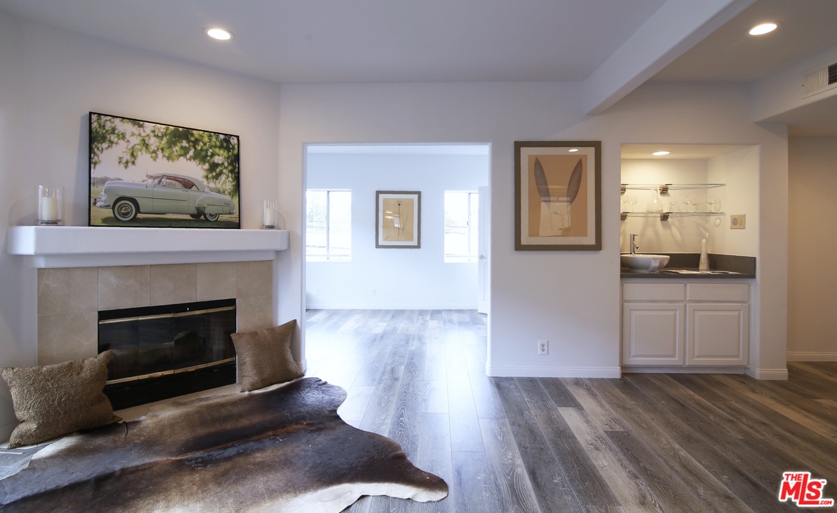 1811 Manning Avenue, Unit 202 Los Angeles, CA 90025 - Photo 4 of 18 a view of a livingroom with wooden floor and a fireplace