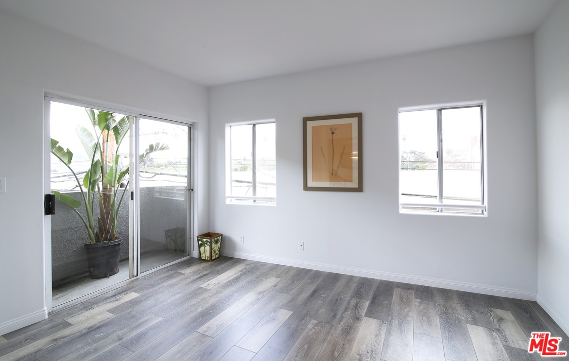1811 Manning Avenue, Unit 202 Los Angeles, CA 90025 - Photo 5 of 18 a view of empty room with wooden floor and fan