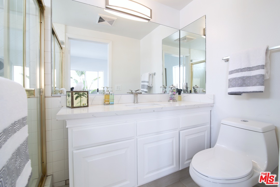 1811 Manning Avenue, Unit 202 Los Angeles, CA 90025 - Photo 6 of 18 a bathroom with a toilet sink and mirror