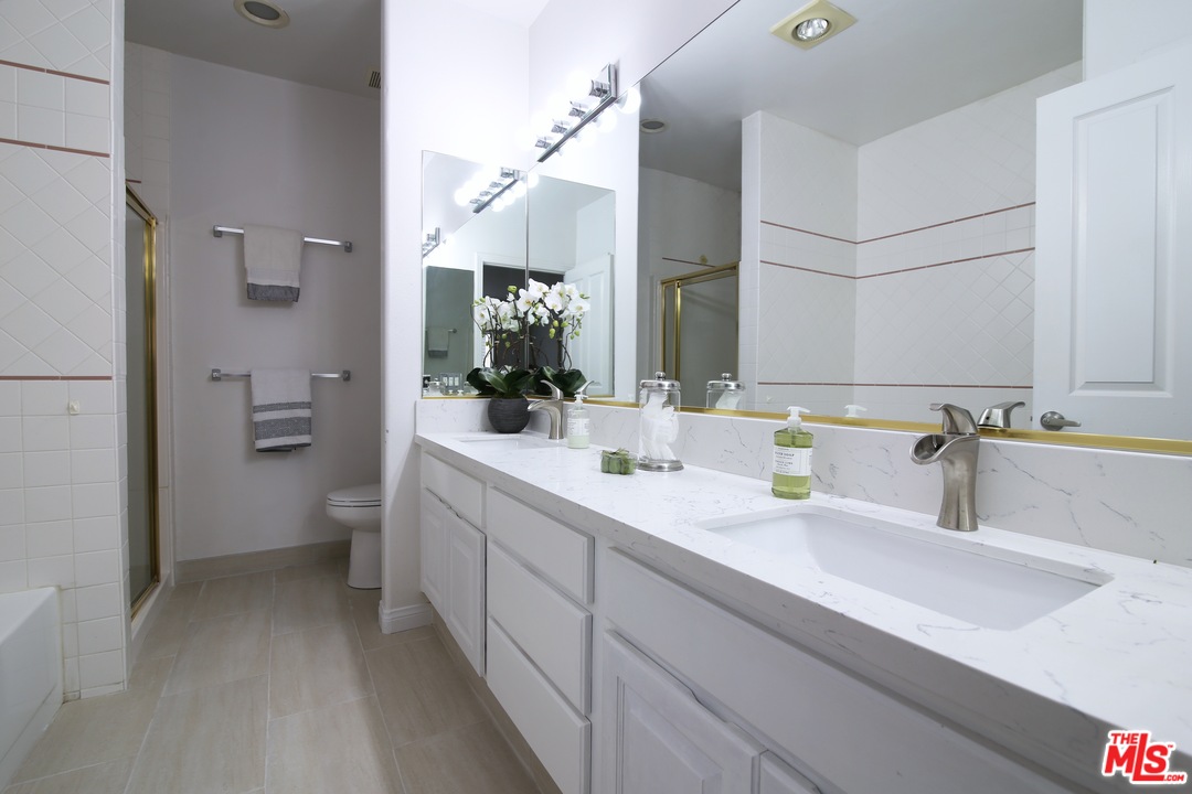 1811 Manning Avenue, Unit 202 Los Angeles, CA 90025 - Photo 10 of 18 a bathroom with a double vanity sink mirror and toilet