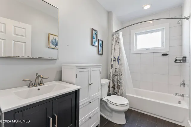 a view of a house with wooden fence and a big yard