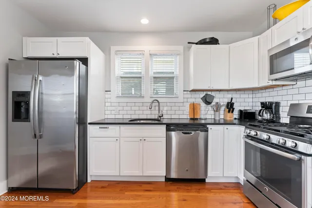 a large kitchen with dining room and chairs