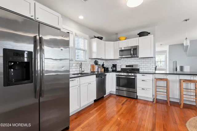 a living room with granite countertop furniture and wooden floor