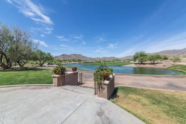 a view of a patio with a table chairs and a backyard