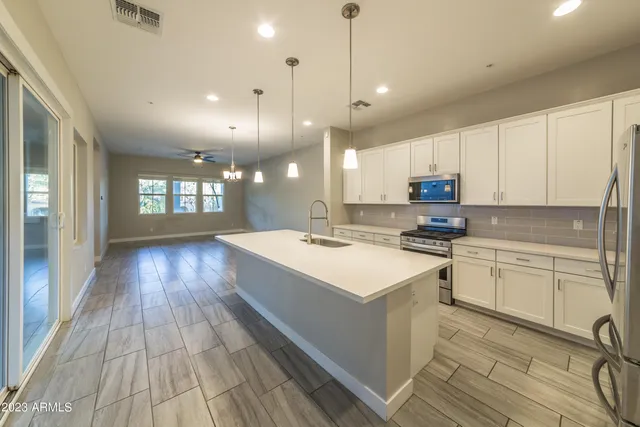 a kitchen with a sink and wooden floor